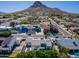 Stunning aerial view of a neighborhood, showcasing beautiful homes and mature landscaping against a mountain backdrop at 15027 N 19Th Way, Phoenix, AZ 85022