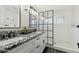 Modern bathroom featuring a dual-sink vanity with granite countertops and a glass-enclosed shower at 15027 N 19Th Way, Phoenix, AZ 85022
