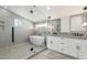 Modern bathroom featuring a glass enclosed shower, soaking tub, and double sink vanity at 15027 N 19Th Way, Phoenix, AZ 85022