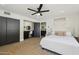 Cozy bedroom with wood-look floors, a ceiling fan, and a built-in desk at 15027 N 19Th Way, Phoenix, AZ 85022