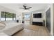 Bright bedroom with wood-look floors, a ceiling fan, and a sliding glass door leading to the backyard at 15027 N 19Th Way, Phoenix, AZ 85022