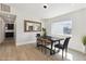 Dining room featuring modern chandelier, light hardwood floors, and a herringbone mirror at 15027 N 19Th Way, Phoenix, AZ 85022