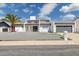 Modern home featuring a xeriscaped front yard, fresh white paint, and a gray garage door at 15027 N 19Th Way, Phoenix, AZ 85022