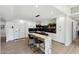 Beautiful kitchen featuring a marble island, white cabinets, black backsplash and stainless appliances at 15027 N 19Th Way, Phoenix, AZ 85022
