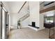 Bright living room featuring modern fireplace, hardwood floors, and black metal staircase at 15027 N 19Th Way, Phoenix, AZ 85022