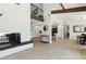 Bright open floor plan featuring a modern fireplace, hardwood floors, and a view of the kitchen at 15027 N 19Th Way, Phoenix, AZ 85022