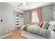 Bedroom with pink curtains and an ensuite closet at 1756 N Summer Cir, Mesa, AZ 85203