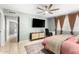 Cozy bedroom with stylish furnishings, featuring a ceiling fan, modern lighting, and a decorative rug at 1756 N Summer Cir, Mesa, AZ 85203