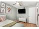 Bedroom with light wood floors and fun wall art at 1756 N Summer Cir, Mesa, AZ 85203