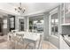 A dining room has a white table and chairs and a view of the backyard pool at 1756 N Summer Cir, Mesa, AZ 85203