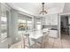 Bright dining area features a white table and chairs with a view of the pool and waterfall at 1756 N Summer Cir, Mesa, AZ 85203