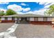 Charming single-story home with a brick facade, white siding, and a well-maintained yard at 1756 N Summer Cir, Mesa, AZ 85203