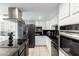 Featuring stainless steel appliances, dark countertops, and white cabinets, this kitchen is modern at 1756 N Summer Cir, Mesa, AZ 85203