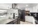 Modern kitchen with stainless steel appliances and white cabinetry and a view of the pool area at 1756 N Summer Cir, Mesa, AZ 85203
