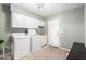 Bright laundry room features white washer and dryer units, ample storage, and a utility sink at 1756 N Summer Cir, Mesa, AZ 85203
