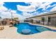 Inviting pool with rock waterfall and slide, complete with a built-in table and seating for ultimate relaxation at 1756 N Summer Cir, Mesa, AZ 85203