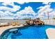Stunning pool area featuring a rock waterfall, a built-in table, and comfortable lounge seating, perfect for summer days at 1756 N Summer Cir, Mesa, AZ 85203