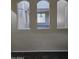 Arched windows offer interior view to hallway, staircase and living room at 1794 N Agave St, Casa Grande, AZ 85122