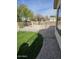Grassy backyard with rock landscaping, metal fence, and window view to the exterior at 1794 N Agave St, Casa Grande, AZ 85122