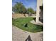 Well-maintained grassy backyard with rock landscaping and privacy fencing at 1794 N Agave St, Casa Grande, AZ 85122