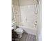 A clean bathroom featuring a shower-tub combo with white tile surround at 1794 N Agave St, Casa Grande, AZ 85122