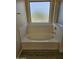 Close-up of soaking tub with tile surround and bright window at 1794 N Agave St, Casa Grande, AZ 85122