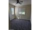 A clean bedroom with neutral walls, plush carpeting, ceiling fan and large windows, offering bright natural light at 1794 N Agave St, Casa Grande, AZ 85122