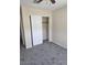 A clean bedroom featuring neutral walls, plush carpeting, and closet with bi-fold doors at 1794 N Agave St, Casa Grande, AZ 85122