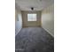 Spacious bedroom with a window, carpet, and a ceiling fan providing natural light and air circulation at 1794 N Agave St, Casa Grande, AZ 85122