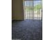 Bright living space with natural light and carpet, featuring a sliding glass door to a private patio at 1794 N Agave St, Casa Grande, AZ 85122