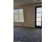 Bright living space featuring a window with blinds and a modern door with glass panels at 1794 N Agave St, Casa Grande, AZ 85122