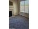 Cozy living area with a tiled fireplace and a bright window letting in natural light at 1794 N Agave St, Casa Grande, AZ 85122