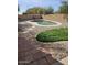 Backyard with a private pool surrounded by decorative rock and green grass at 1794 N Agave St, Casa Grande, AZ 85122