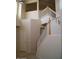 Staircase with wooden handrail, white spindles, and neutral colored walls at 1794 N Agave St, Casa Grande, AZ 85122