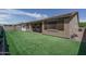 The backyard has artificial turf, a block wall, and a covered patio at 18731 W San Juan Ave, Litchfield Park, AZ 85340