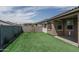 The backyard has artificial turf, a block wall, and a covered patio at 18731 W San Juan Ave, Litchfield Park, AZ 85340
