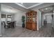 Spacious dining area with an antique hutch and wood-look tile flooring at 18731 W San Juan Ave, Litchfield Park, AZ 85340
