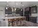Elegant kitchen featuring a large center island, modern stainless steel appliances, and dark wood cabinetry at 18731 W San Juan Ave, Litchfield Park, AZ 85340