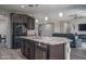 Modern kitchen showcasing a spacious island with sink, stainless steel appliances, and an open concept design at 18731 W San Juan Ave, Litchfield Park, AZ 85340