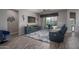 Cozy living room featuring hard wood floors, a large TV, and comfortable blue seating at 18731 W San Juan Ave, Litchfield Park, AZ 85340