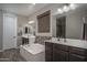 Luxurious primary bathroom featuring double vanities, a soaking tub, and modern finishes at 18731 W San Juan Ave, Litchfield Park, AZ 85340