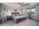 Spacious primary bedroom with a ceiling fan and decorative artwork adding character at 18731 W San Juan Ave, Litchfield Park, AZ 85340