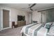 Cozy main bedroom boasts a ceiling fan and a dresser with wall-mounted television at 18731 W San Juan Ave, Litchfield Park, AZ 85340