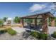 Community park with a shaded picnic area, a barbecue grill and playground equipment at 18731 W San Juan Ave, Litchfield Park, AZ 85340