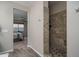 Walk through showing the primary bedroom leading to a full tile standing shower at 18731 W San Juan Ave, Litchfield Park, AZ 85340