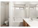 Bright bathroom features a shower-tub combo with white tile surround, a single sink, and neutral wall color at 1944 N Lazona Dr, Mesa, AZ 85203