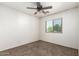 Bedroom with plush carpet flooring, ceiling fan, and a window for natural light at 1944 N Lazona Dr, Mesa, AZ 85203