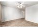Bedroom with neutral carpet, white walls, ceiling fan, and curtains at 1944 N Lazona Dr, Mesa, AZ 85203