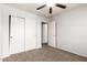 Bedroom with plush carpet flooring, a ceiling fan, and a sliding door closet for storage at 1944 N Lazona Dr, Mesa, AZ 85203
