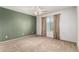 Bedroom with neutral carpet, green accent wall, a ceiling fan, and curtains at 1944 N Lazona Dr, Mesa, AZ 85203